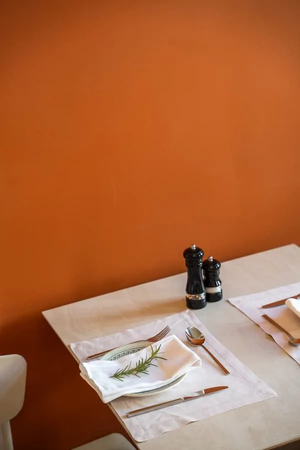 A table against the ochre wall