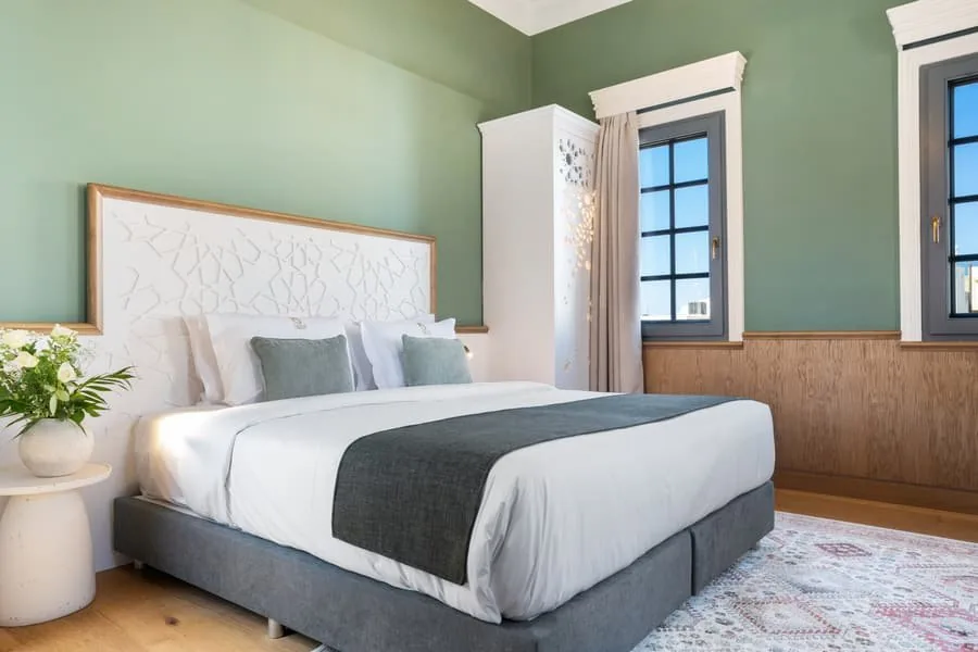 A bed beside the arched window