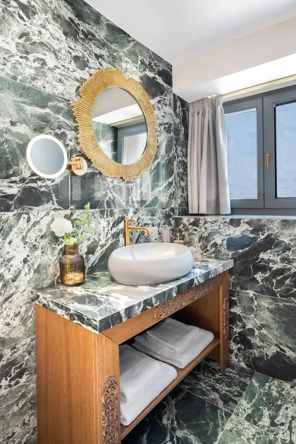 A marble bathroom with a window